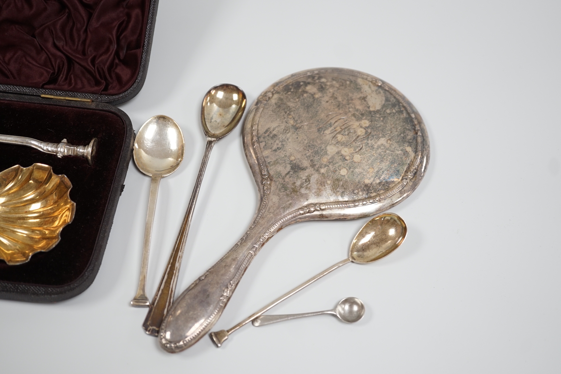 A cased pair of Victorian silver seal top serving spoons, Francis Higgins, London, 1887, 21.5cm, four other sundry silver spoons and a silver mounted hand mirror.